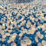 virgin plastic pellets and blue plastic pigment pellets mix